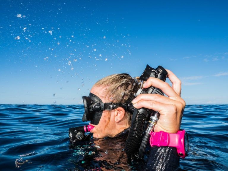 a scuba diver is taking a picture of the ocean