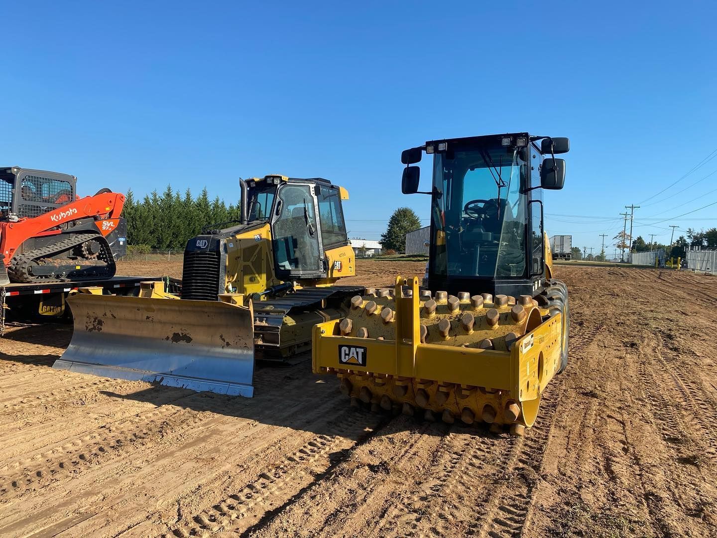 A yellow excavator is digging a hole in the woods.