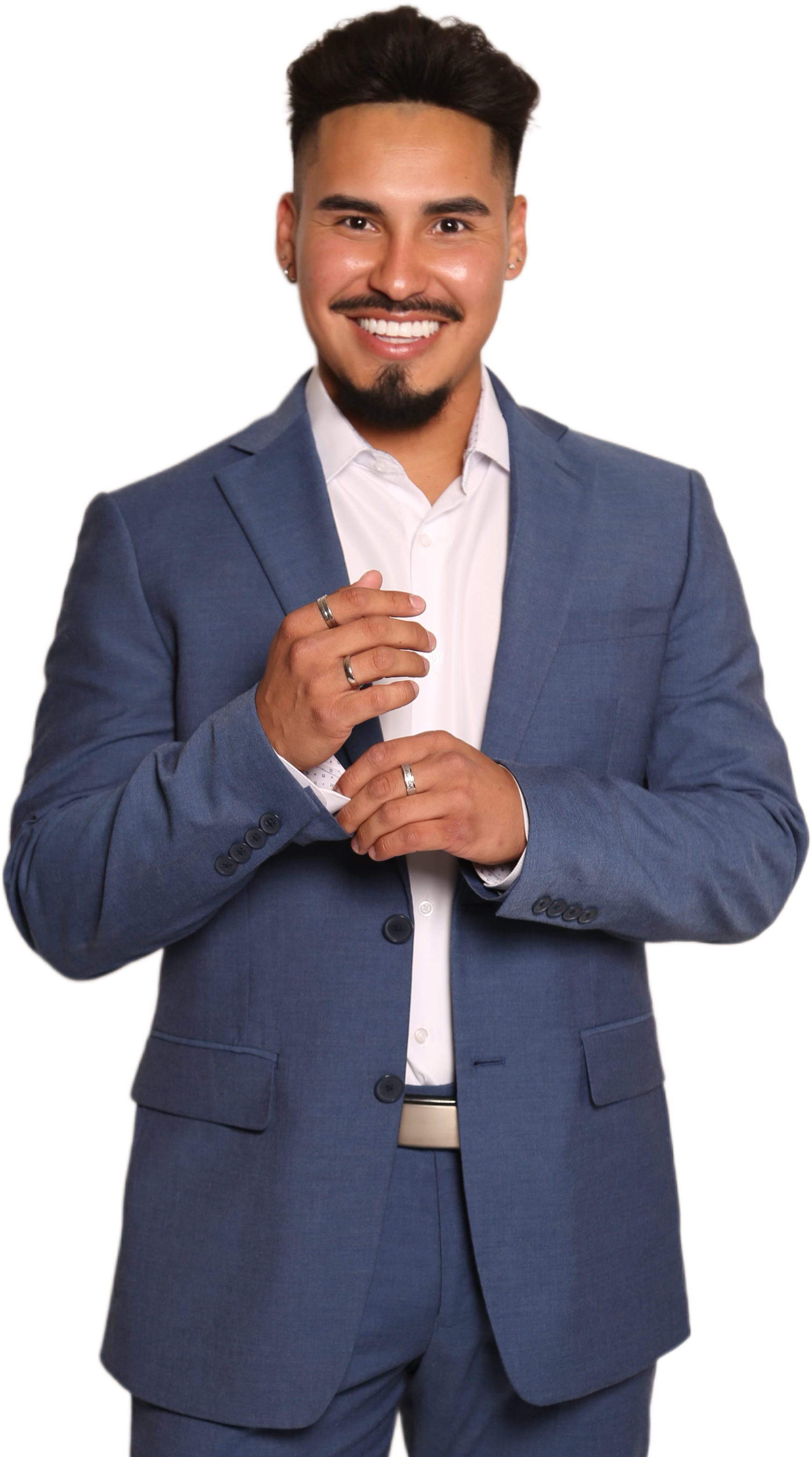 A woman is sitting at a desk with a laptop and a vase of flowers.