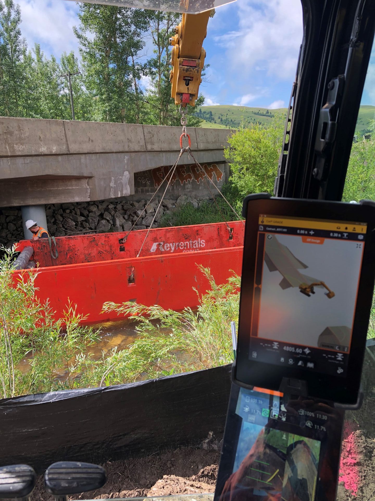 A crane is being used to lift a bridge over a body of water.