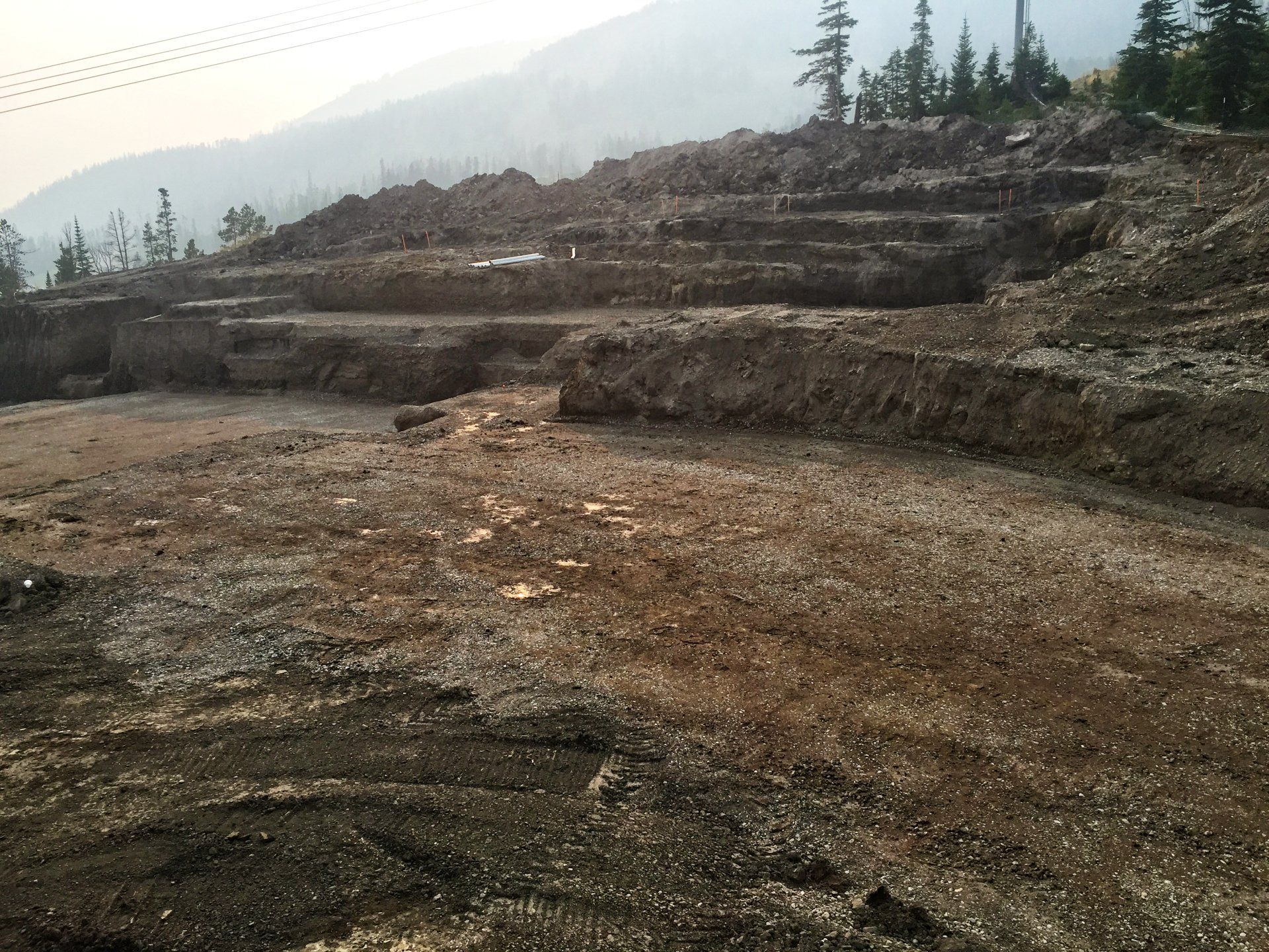 A dirt field with a mountain in the background