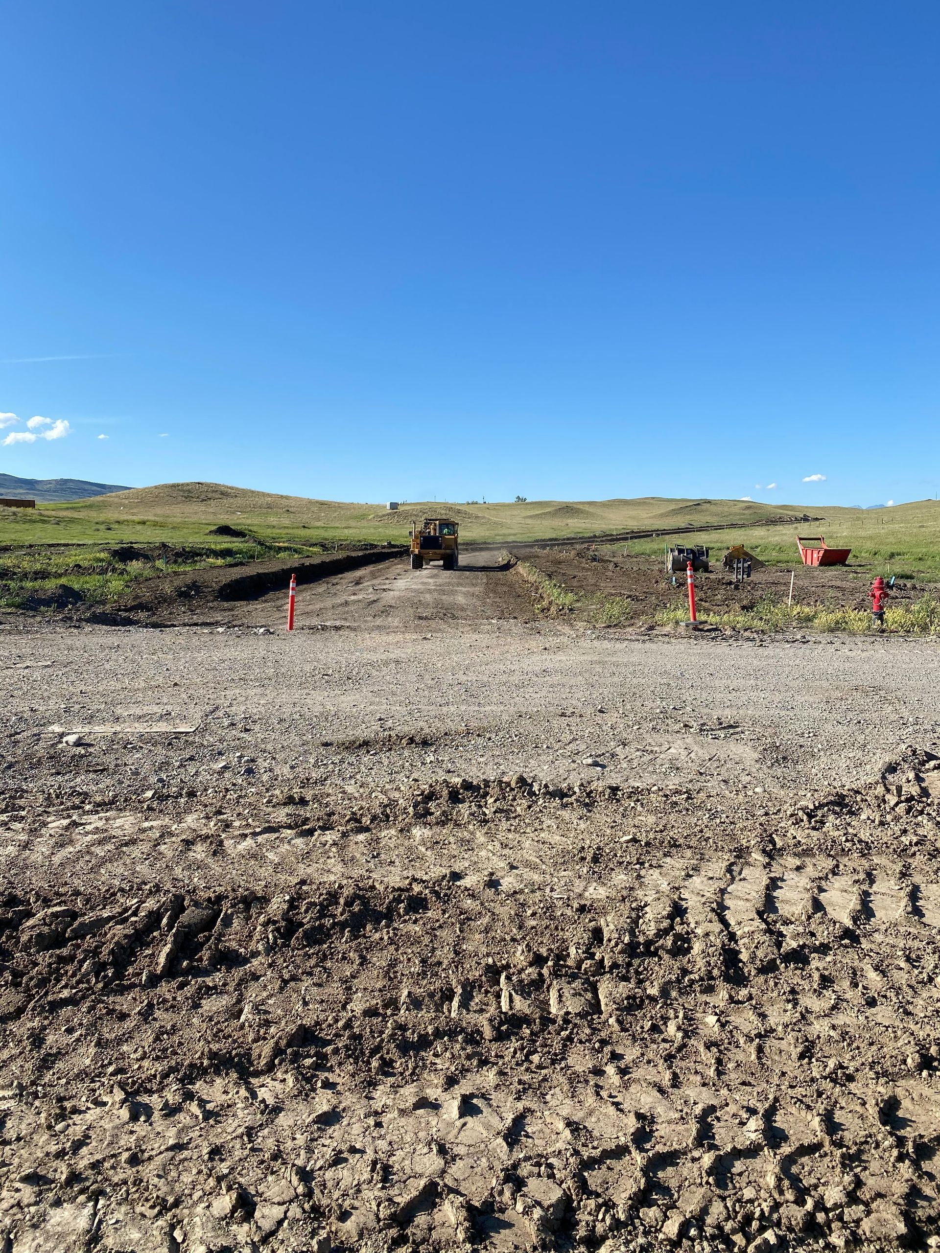 A dirt field with a blue sky in the background.