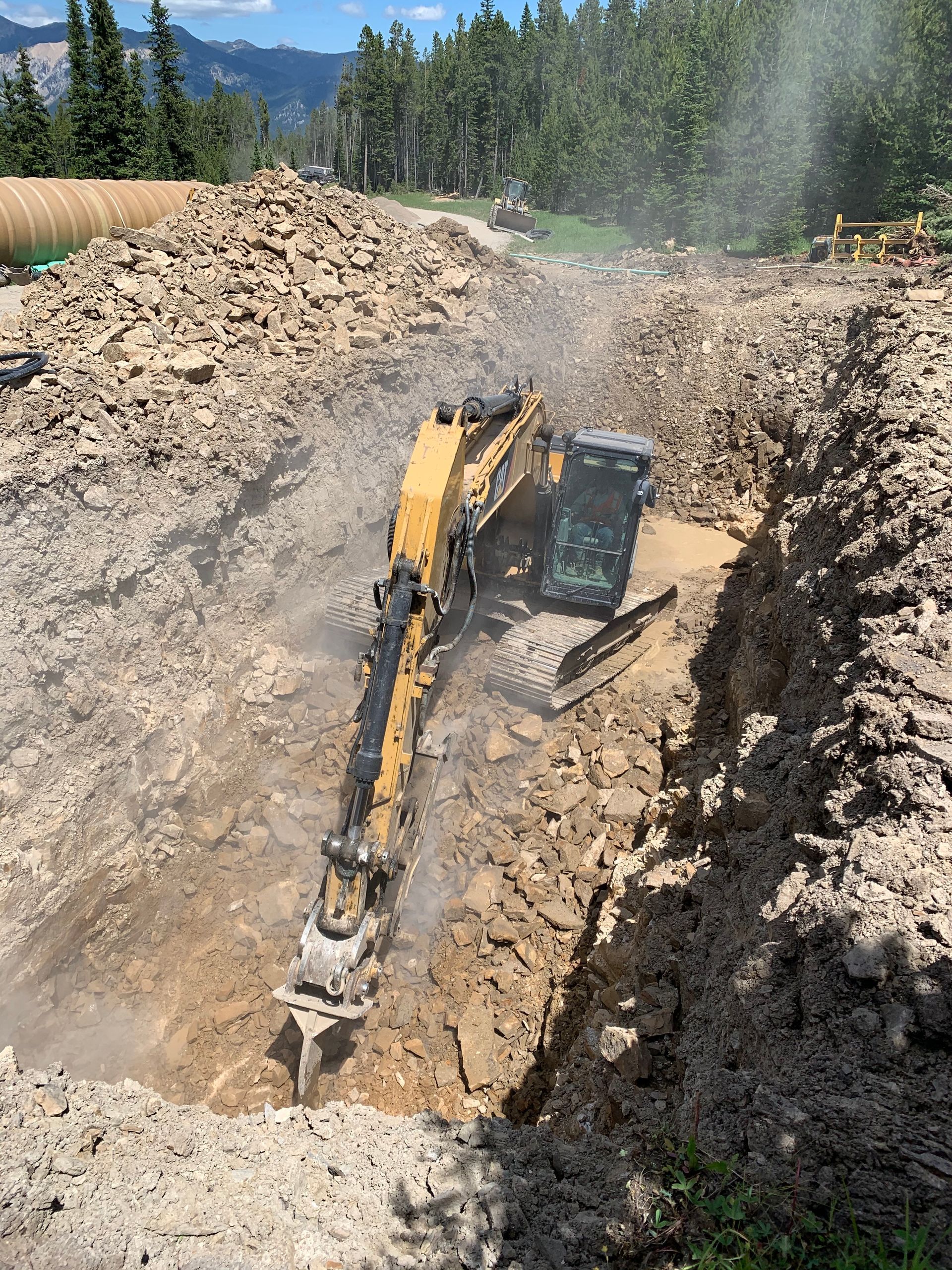 A yellow excavator is digging a hole in the dirt.