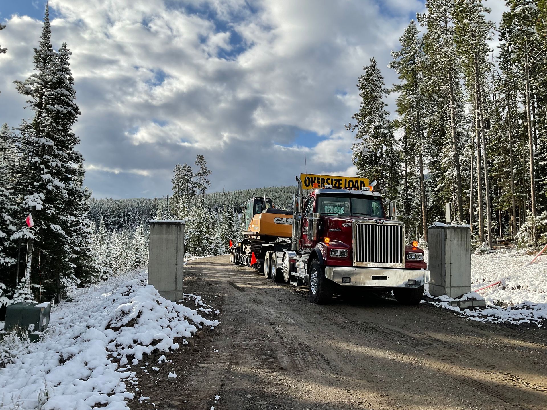 A truck is parked on the side of a snowy road.