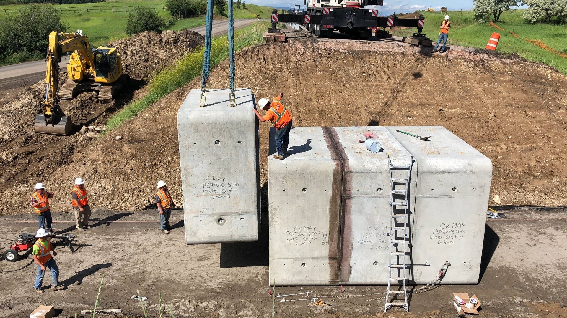 A group of construction workers are working on a large concrete structure.