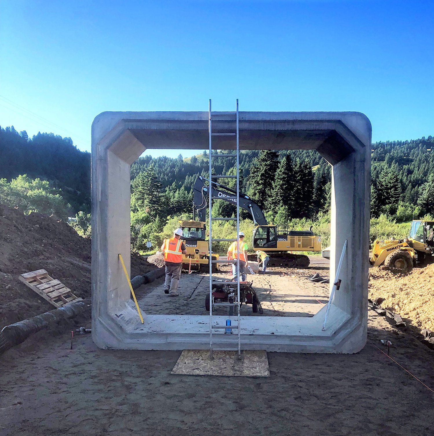 Construction workers are working on a large concrete structure