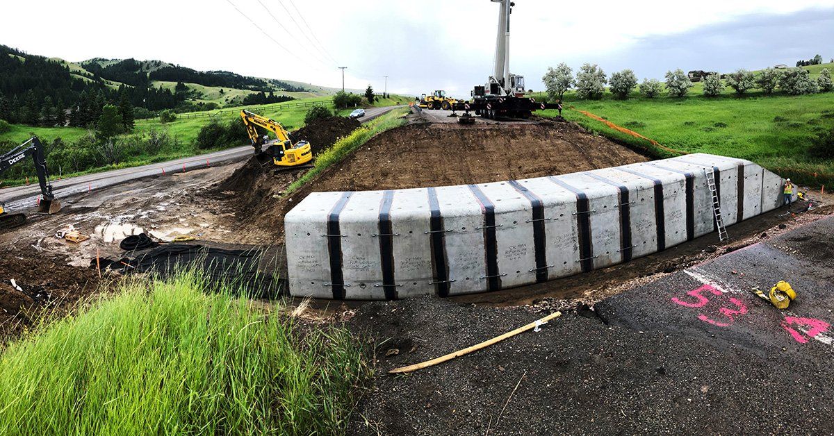 A large concrete block is sitting on the side of a road.