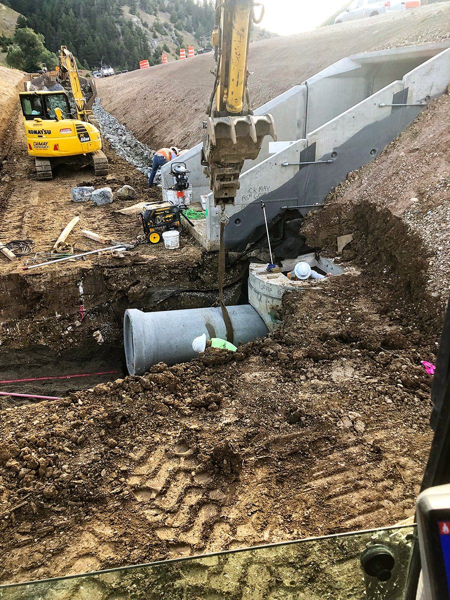 A yellow excavator is digging a hole in the dirt.