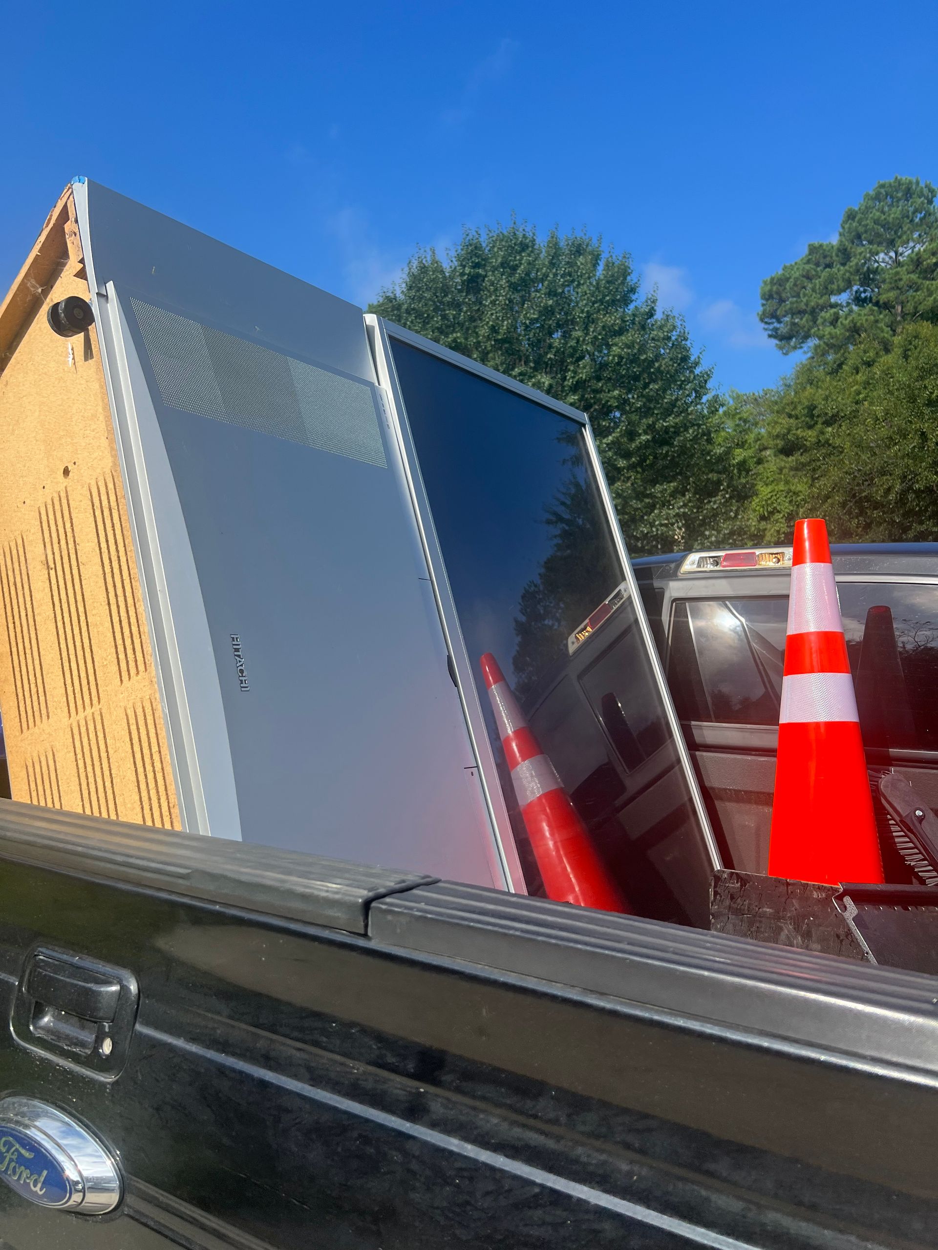 The back of a truck with a bunch of cones in it