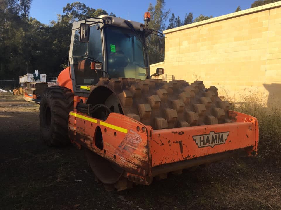 A Hamm roller is parked in a dirt lot — BB & F Constructions Pty Ltd In Taree, NSW