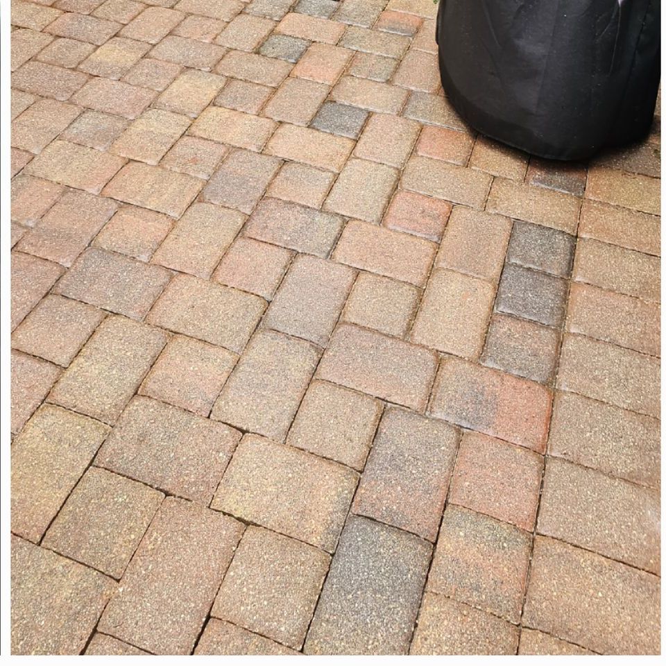 A brick floor with a black bag on it