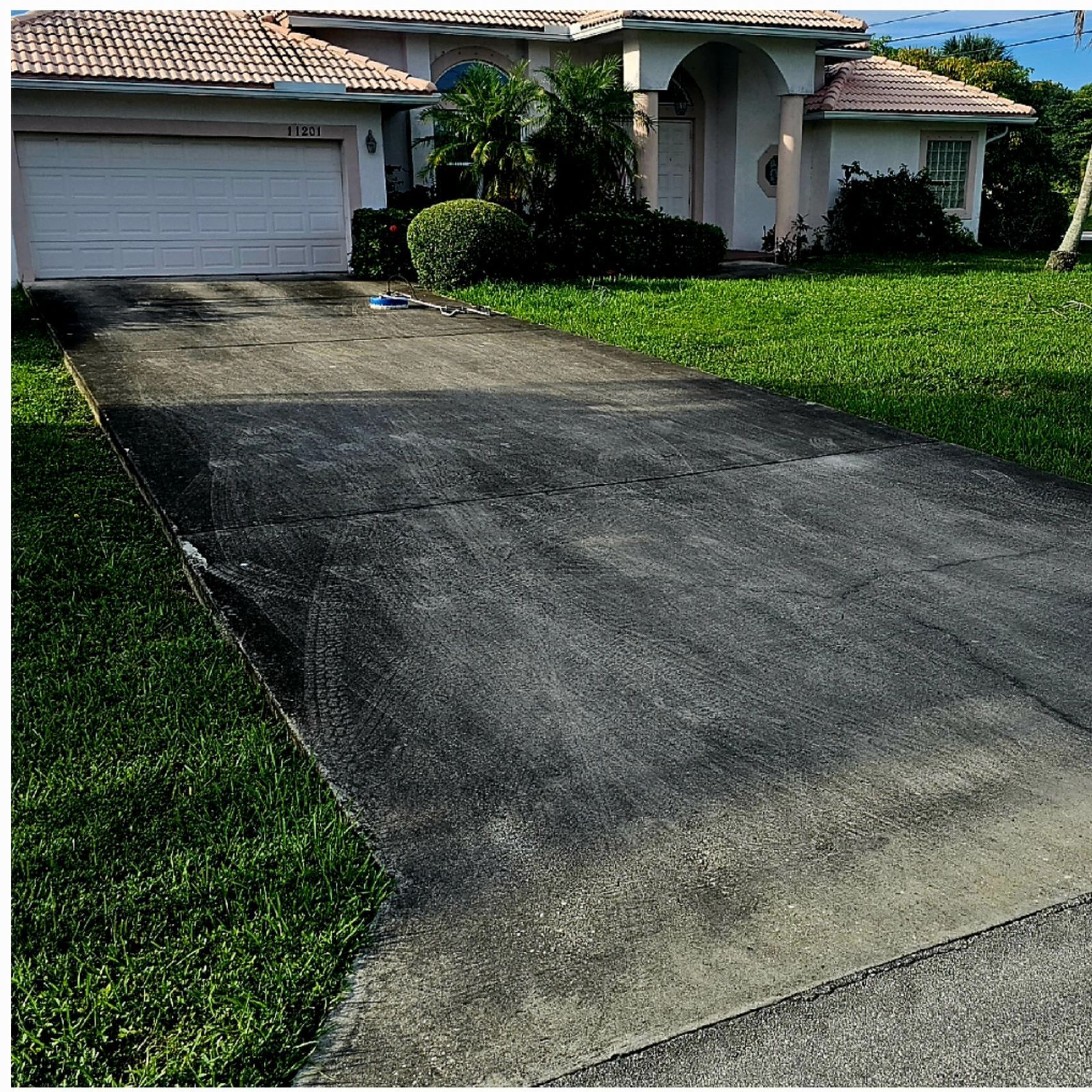 A driveway leading to a house with a white garage door