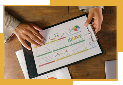 A person is holding a clipboard with a graph on it.