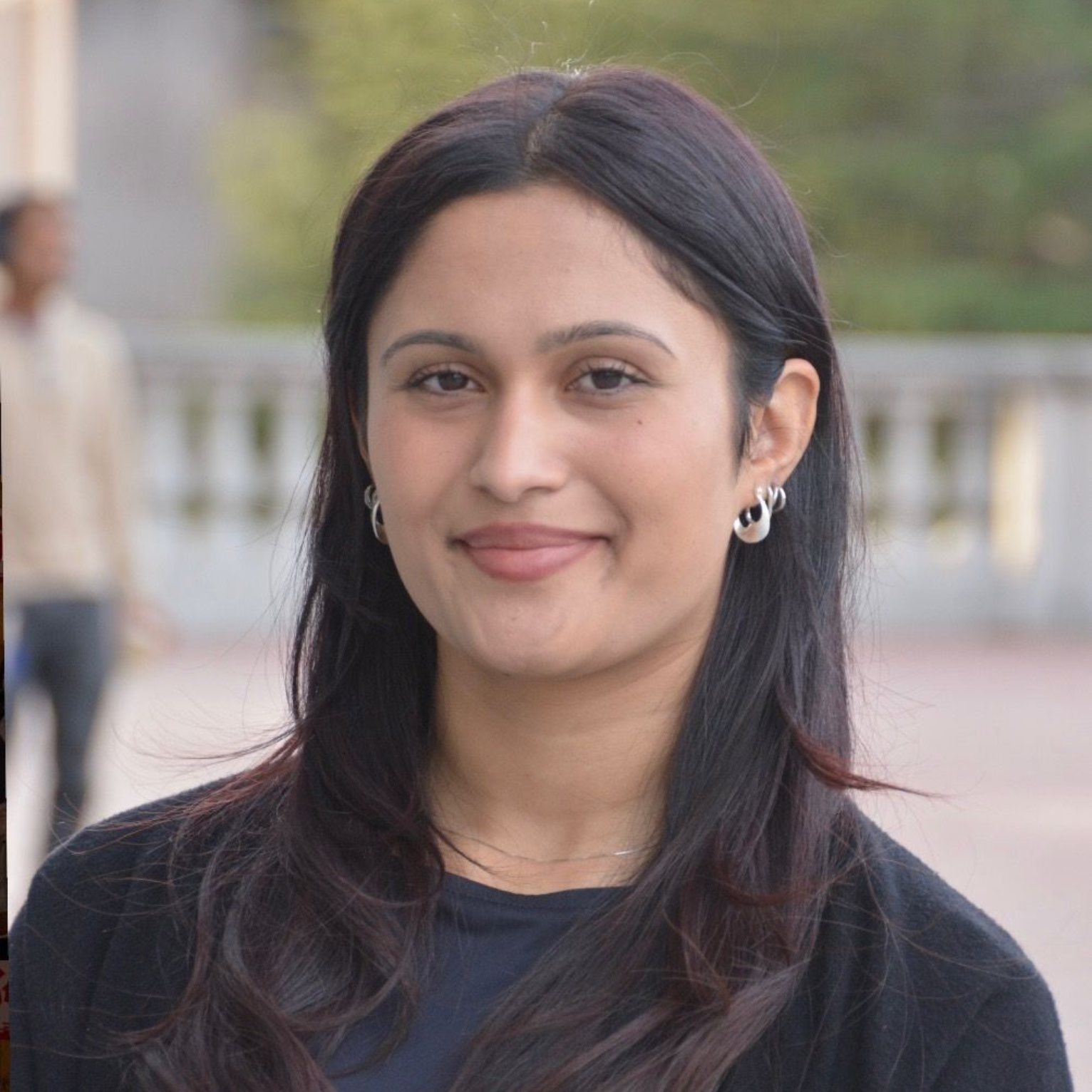 A man in a suit and white shirt is smiling for the camera.