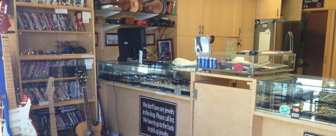 Various guitars jewlery and ukuleles at pawn shop in Honolulu
