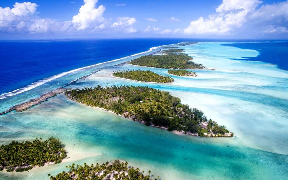 An aerial view of a group of small islands in the middle of the ocean.