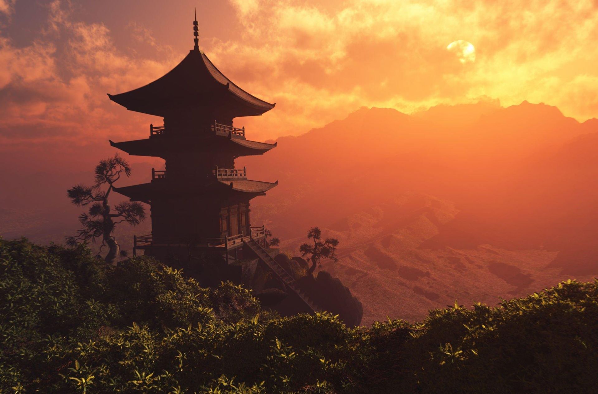 A silhouette of a pagoda in the mountains at sunset