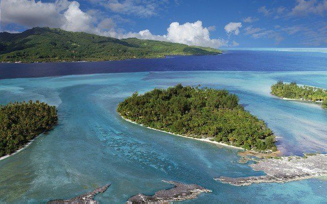 A group of small islands in the middle of a large body of water.