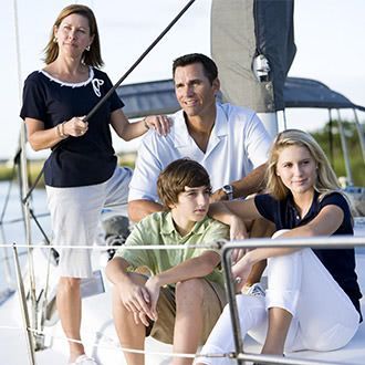 A family is posing for a picture on a sailboat