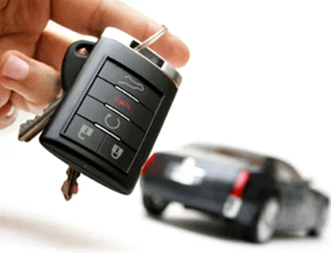 a locksmith is working on the steering wheel of a car .