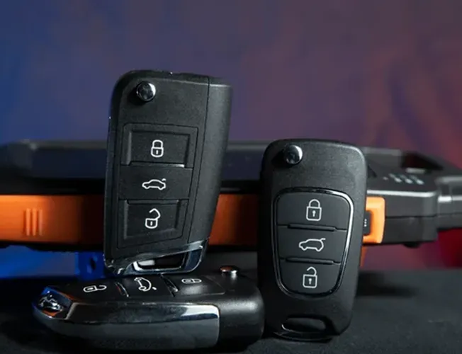 a locksmith is working on the steering wheel of a car .