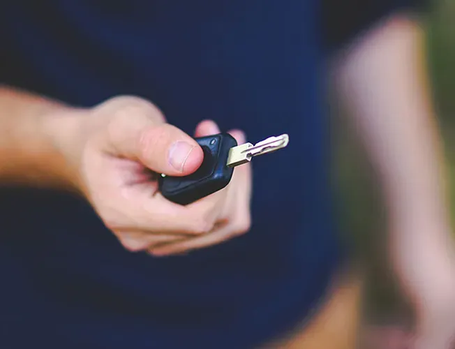 a locksmith is working on the steering wheel of a car .