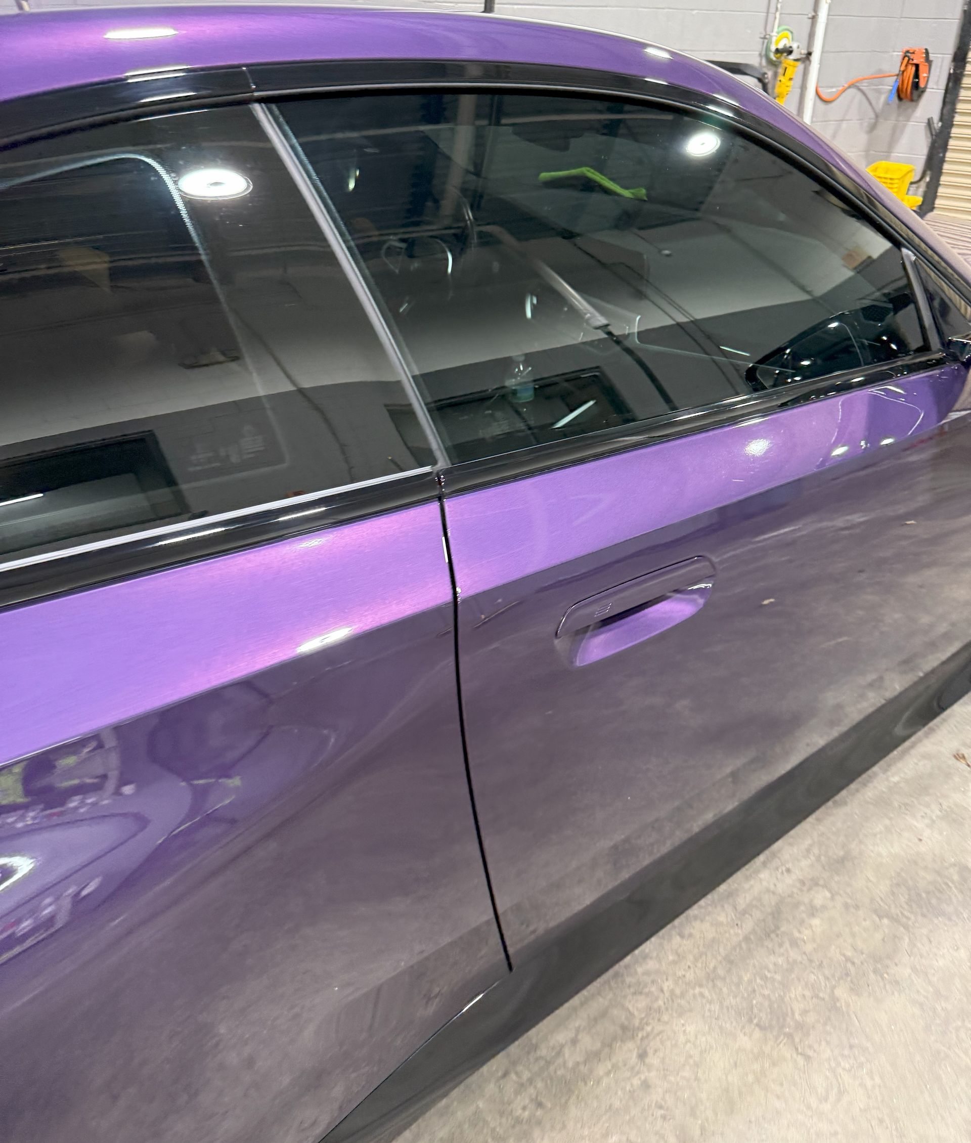 Purple car door with tinted windows and a shiny ceramic coating