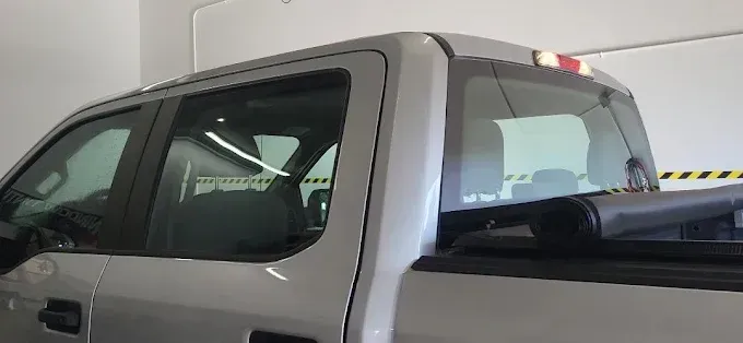 Silver pickup truck parked indoors.