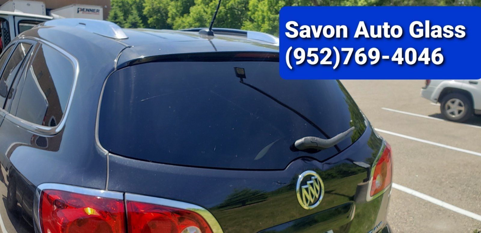 Black SUV with tinted windows; Savon Auto Glass ad with phone number.