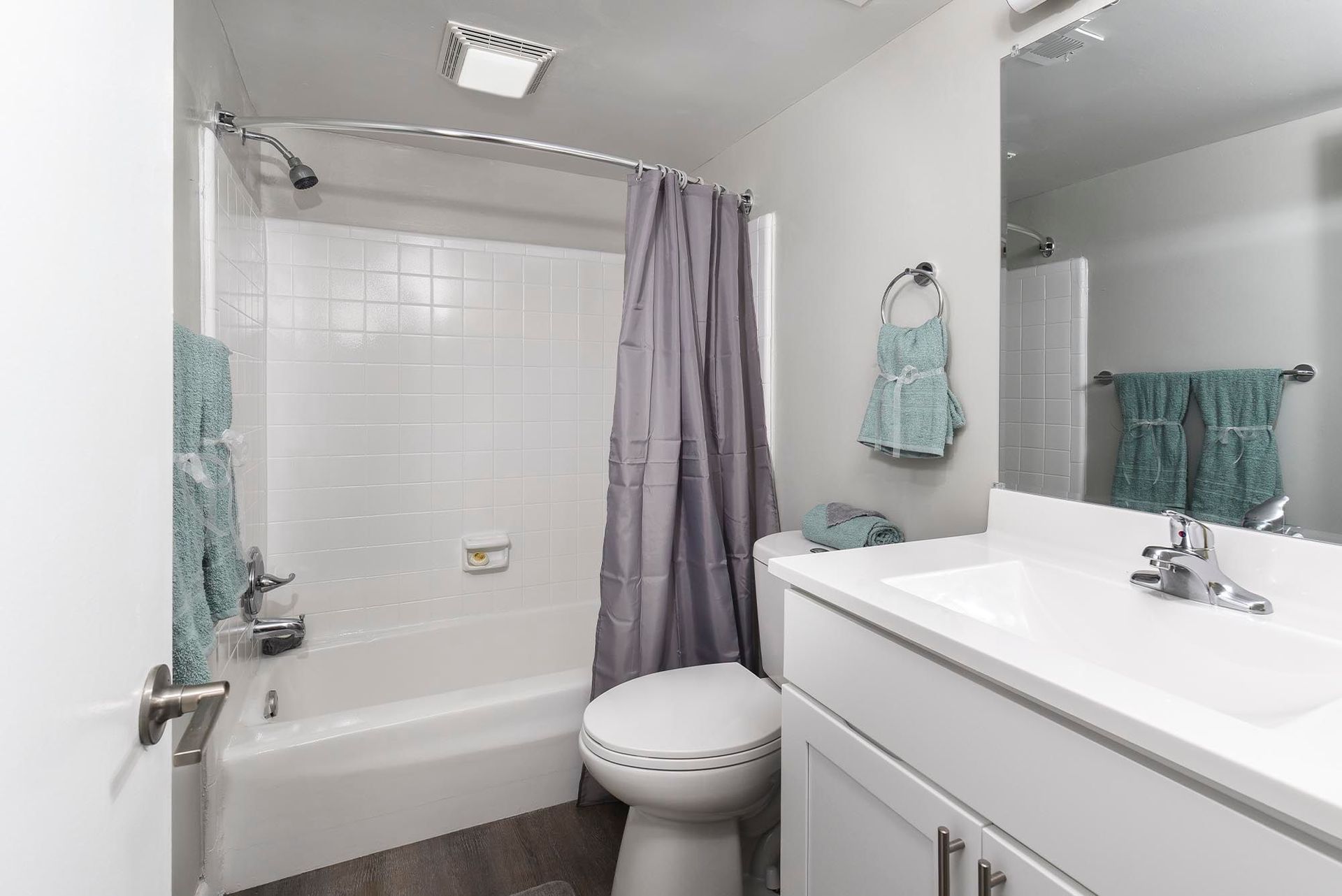 Bathroom with tiled shower-tub combo, toilet, and white vanity at Chesapeake Pointe, offers Apartments for Rent in Chesapeake, VA.