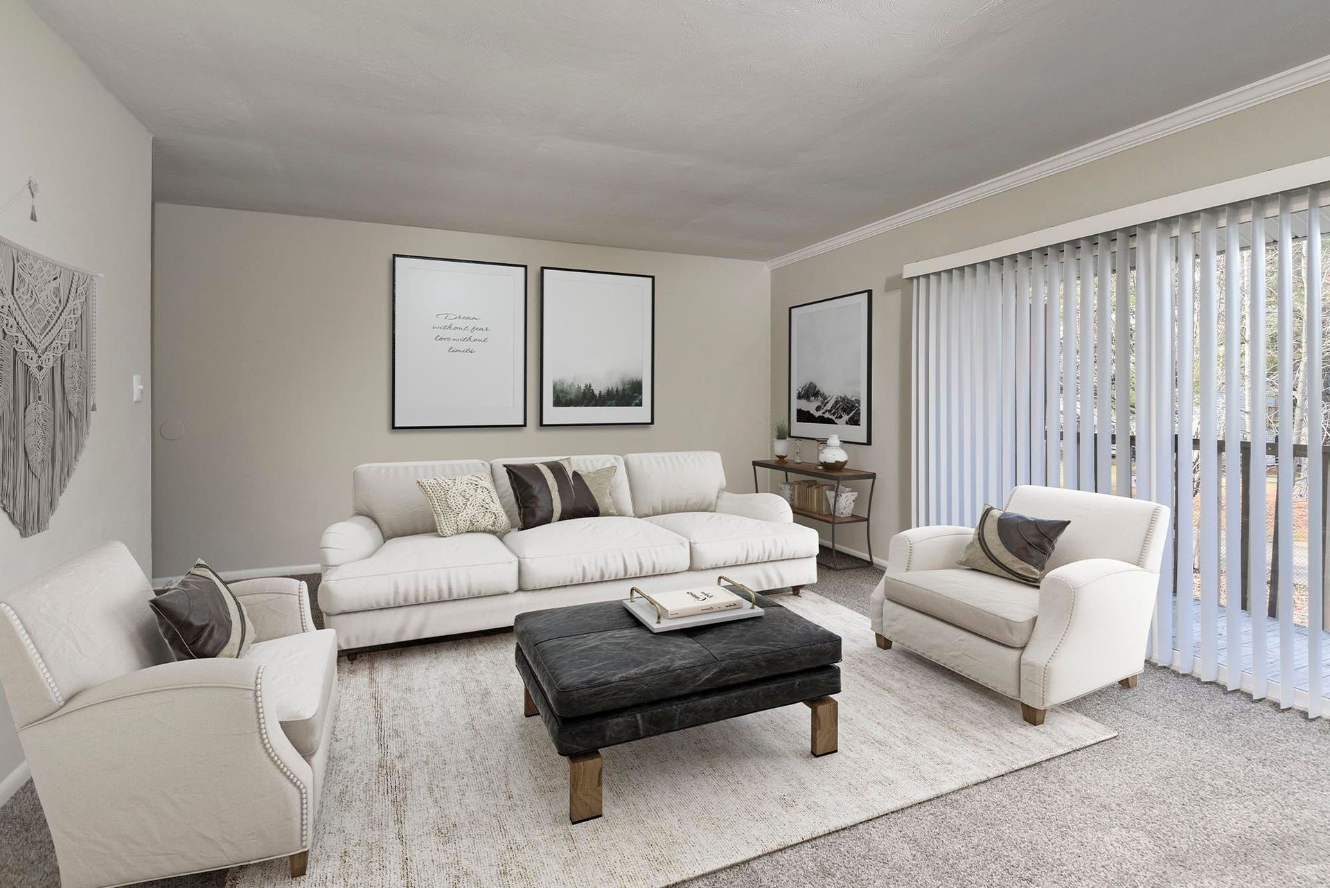 Living room in an apartment with white sofas and vertical blinds by large windows at Chesapeake Pointe, offers apartments in Chesapeake, VA.