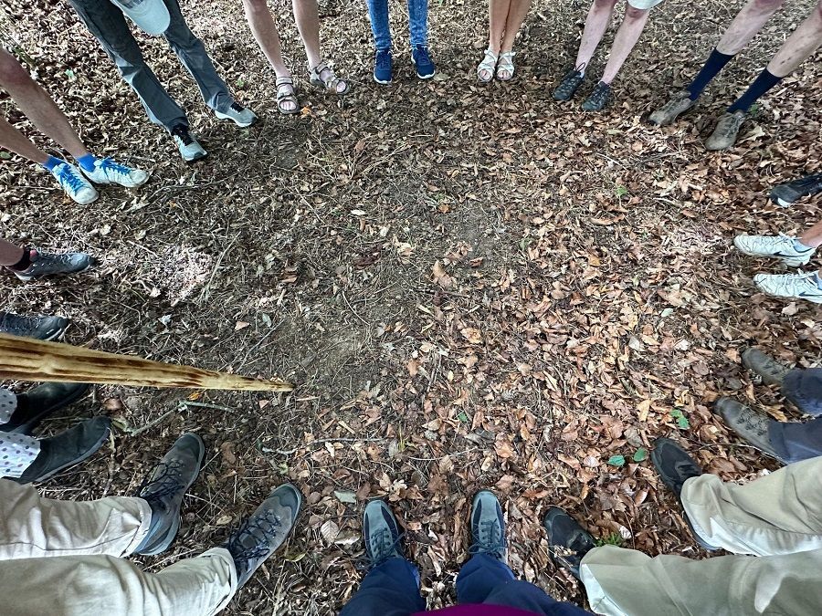 A picture of a group of pilgrims huddled in a standing circle