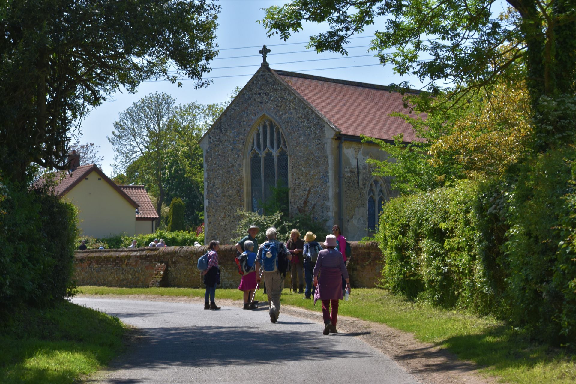A group of pilgrims arriving at a church