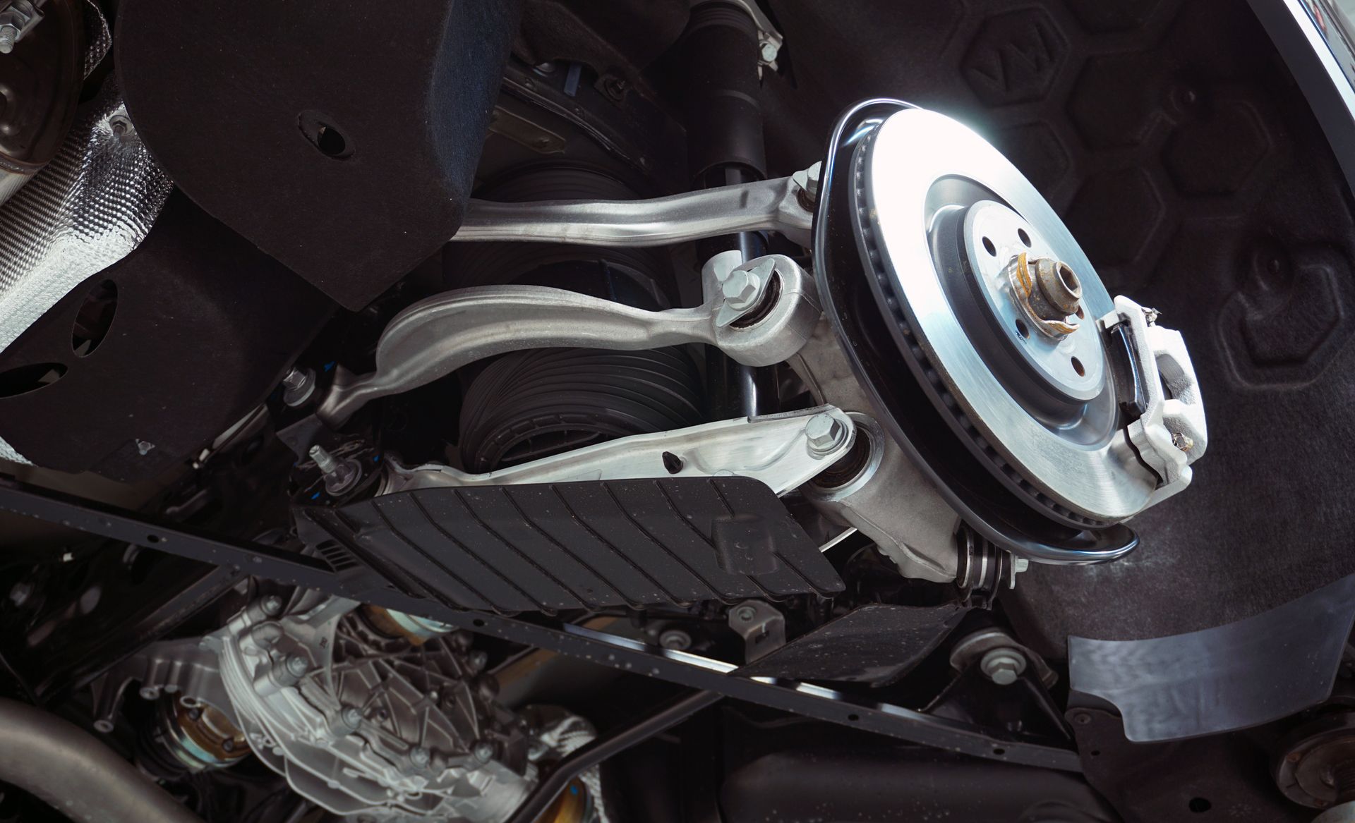 A close up of the underside of a car with a brake disc