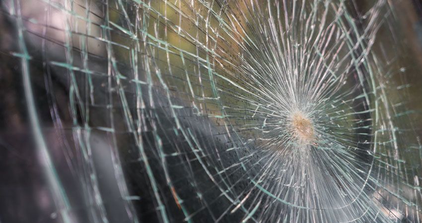 a close up of a broken glass window .