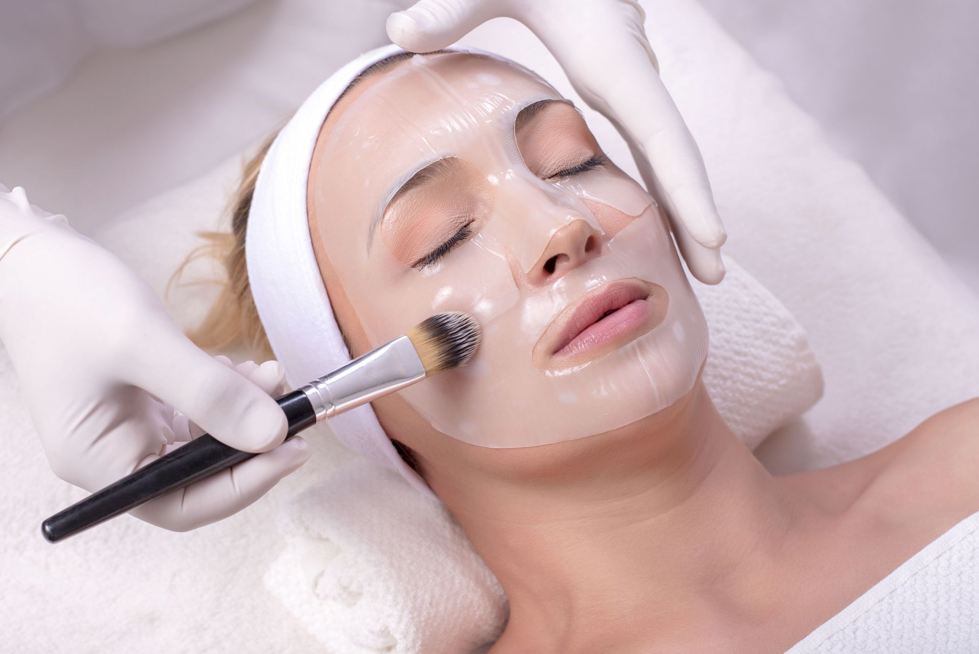 A woman is getting a facial treatment at a beauty salon.