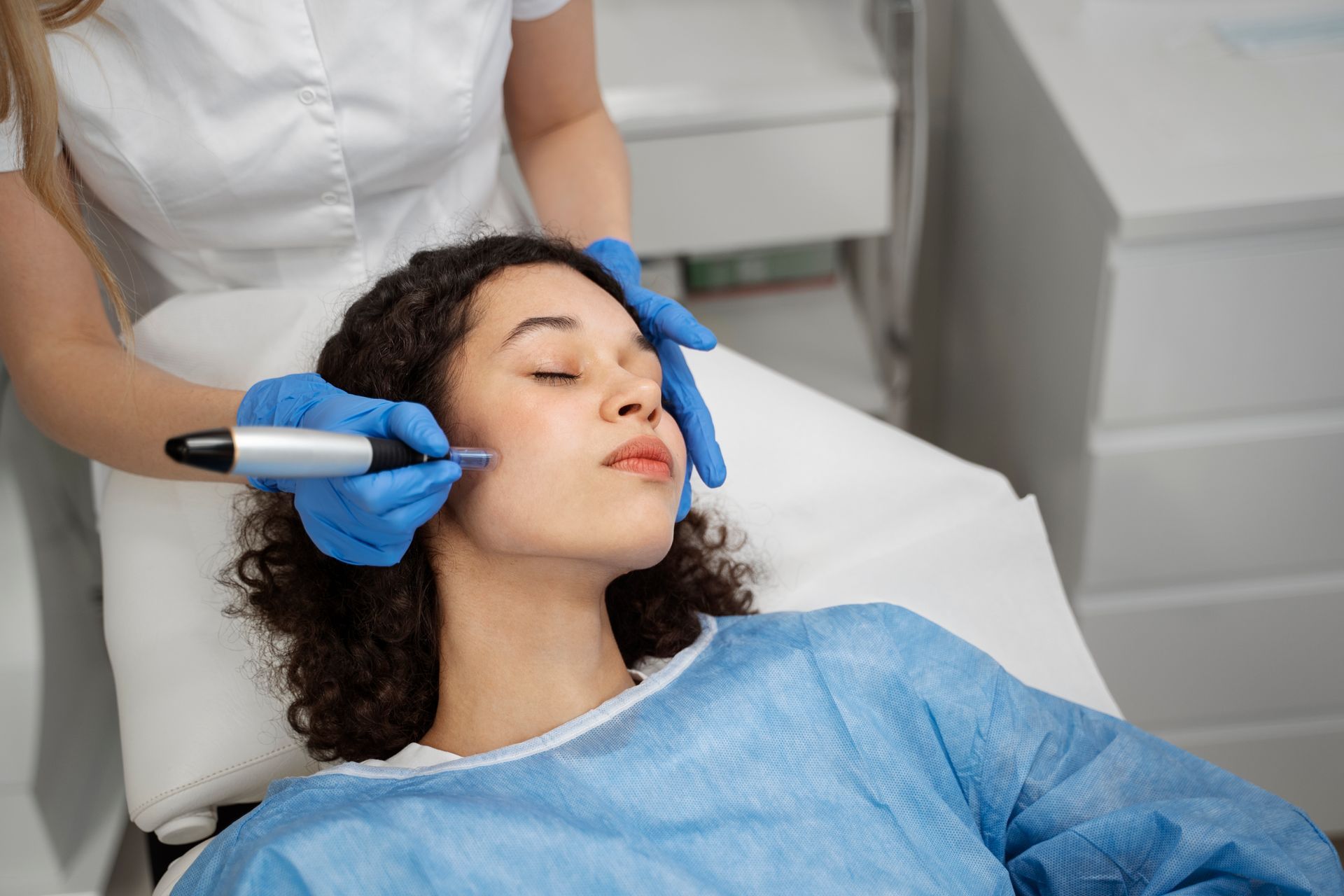 A woman is getting a facial treatment in a beauty salon.