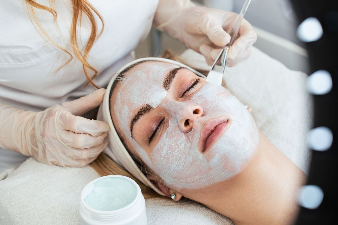 A woman is getting a facial treatment at a beauty salon.