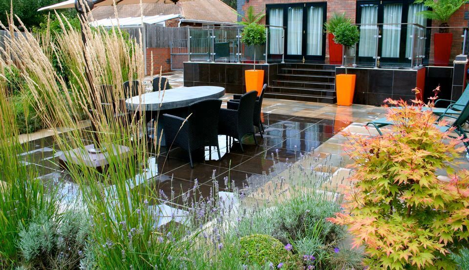 table and chairs in a garden after the rain