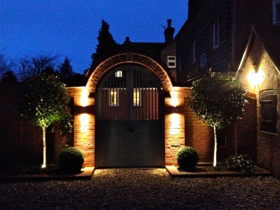 gate entrance to a garden at night