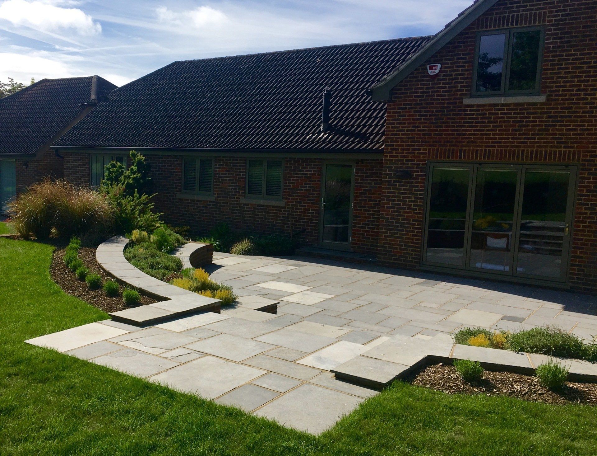 chairs in the middle of paved area near a garden