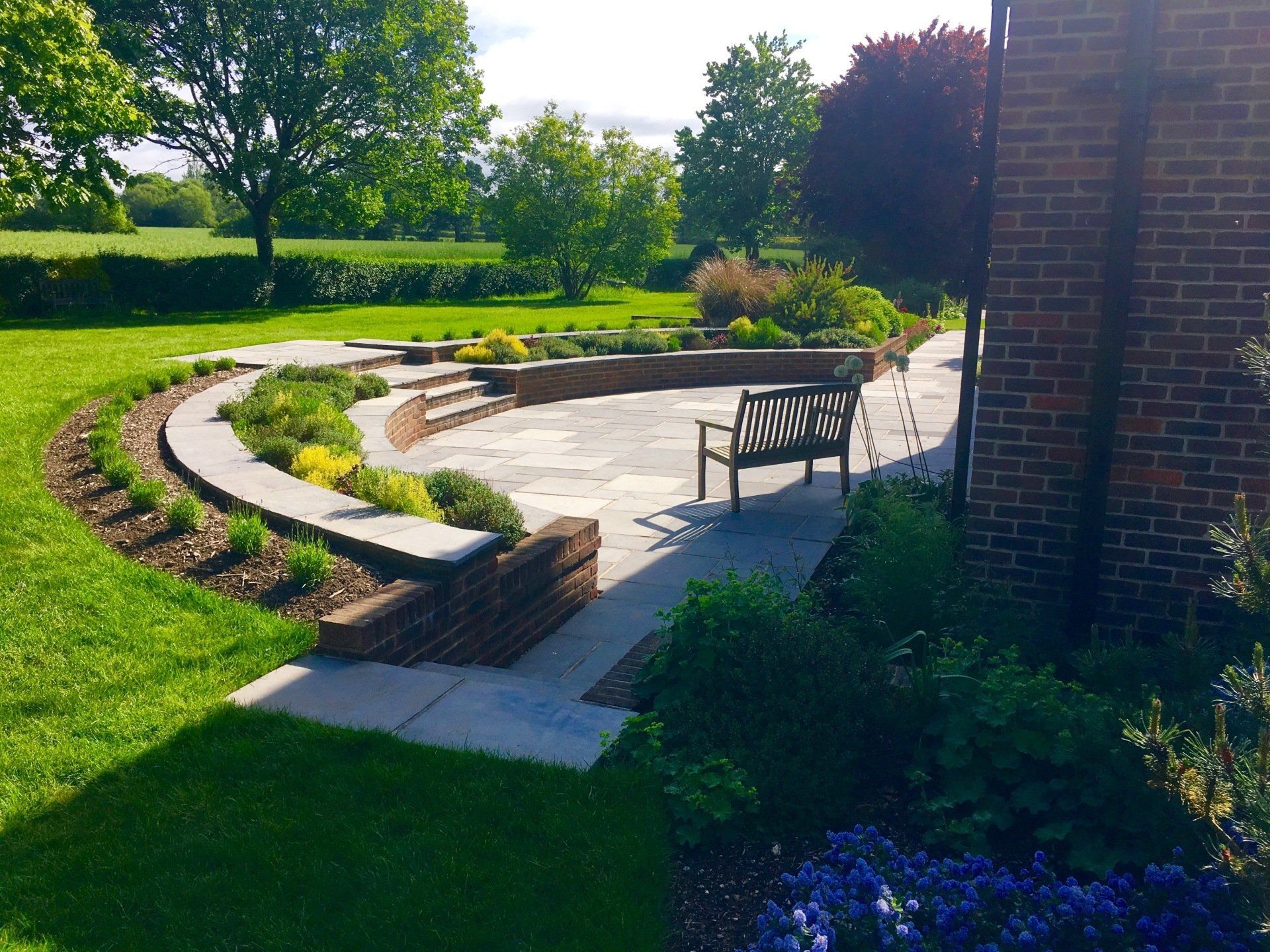 paved alley between a house and the back yard garden