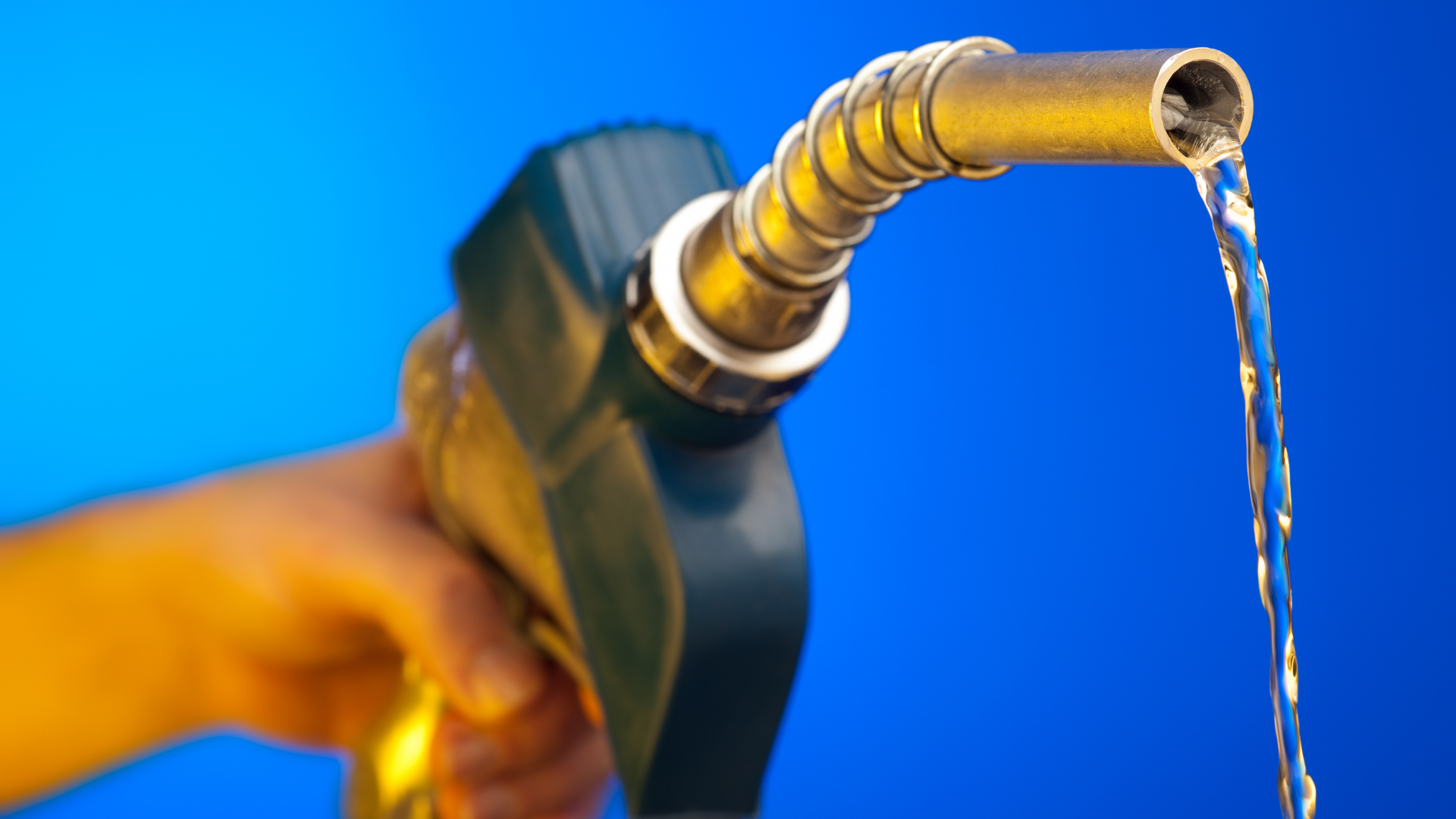 A person is pumping gas into a gas pump at a gas station.
