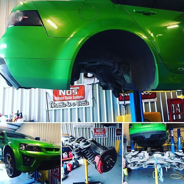A Green Car Is Being Worked On The Garage — ProStreet Automotive & Fabrication In Cardiff, NSW