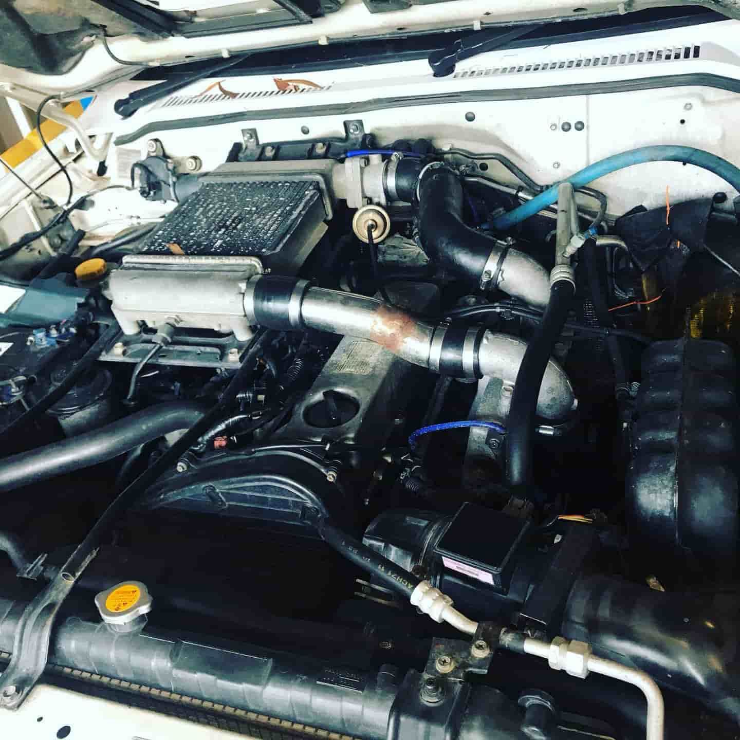 A Close Up Of A Car Engine With The Hood Open — ProStreet Automotive & Fabrication In Cardiff, NSW
