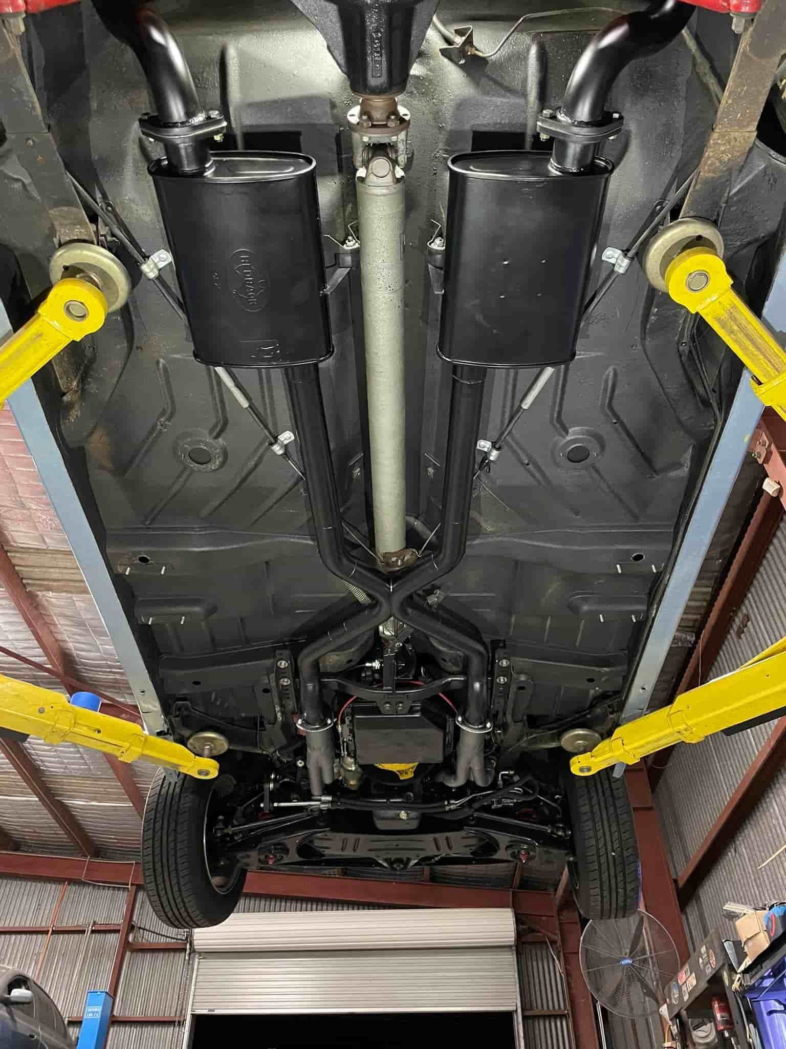 A Car Is Sitting On A Lift In A Garage — ProStreet Automotive & Fabrication In Cardiff, NSW