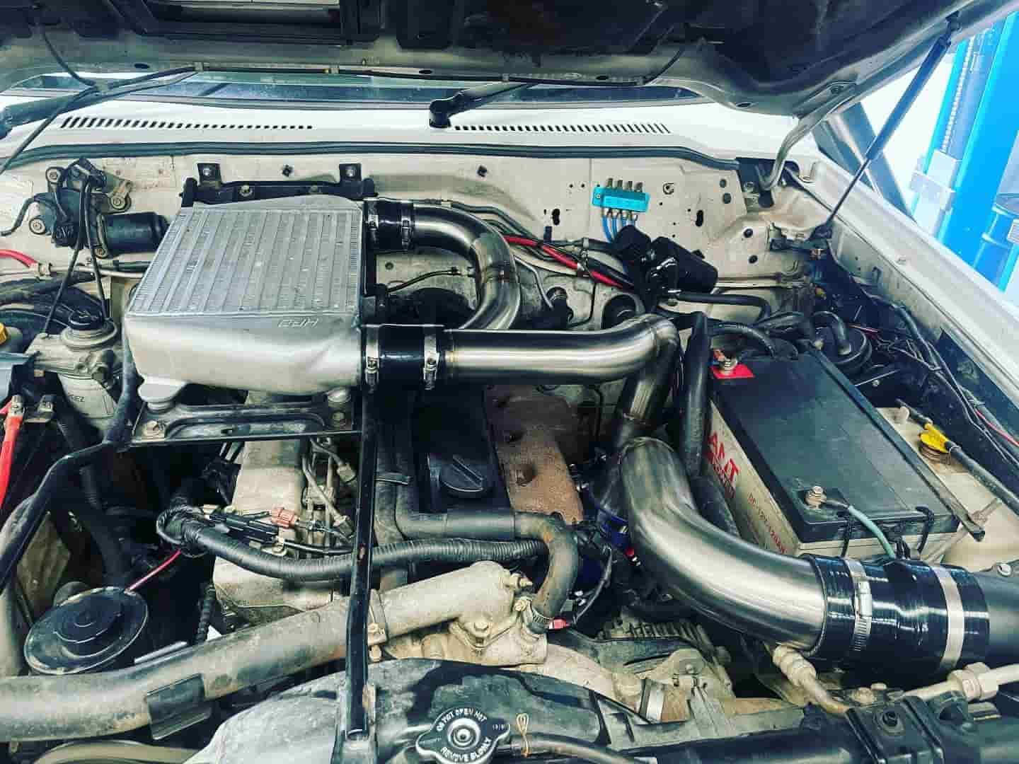 A Close Up Of A Car Engine With The Hood Up — ProStreet Automotive & Fabrication In Cardiff, NSW