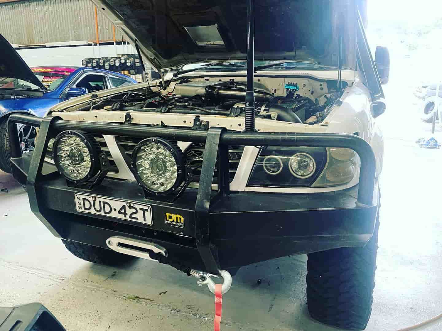 A Truck With The Hood Open Is Parked In A Garage — ProStreet Automotive & Fabrication In Cardiff, NSW
