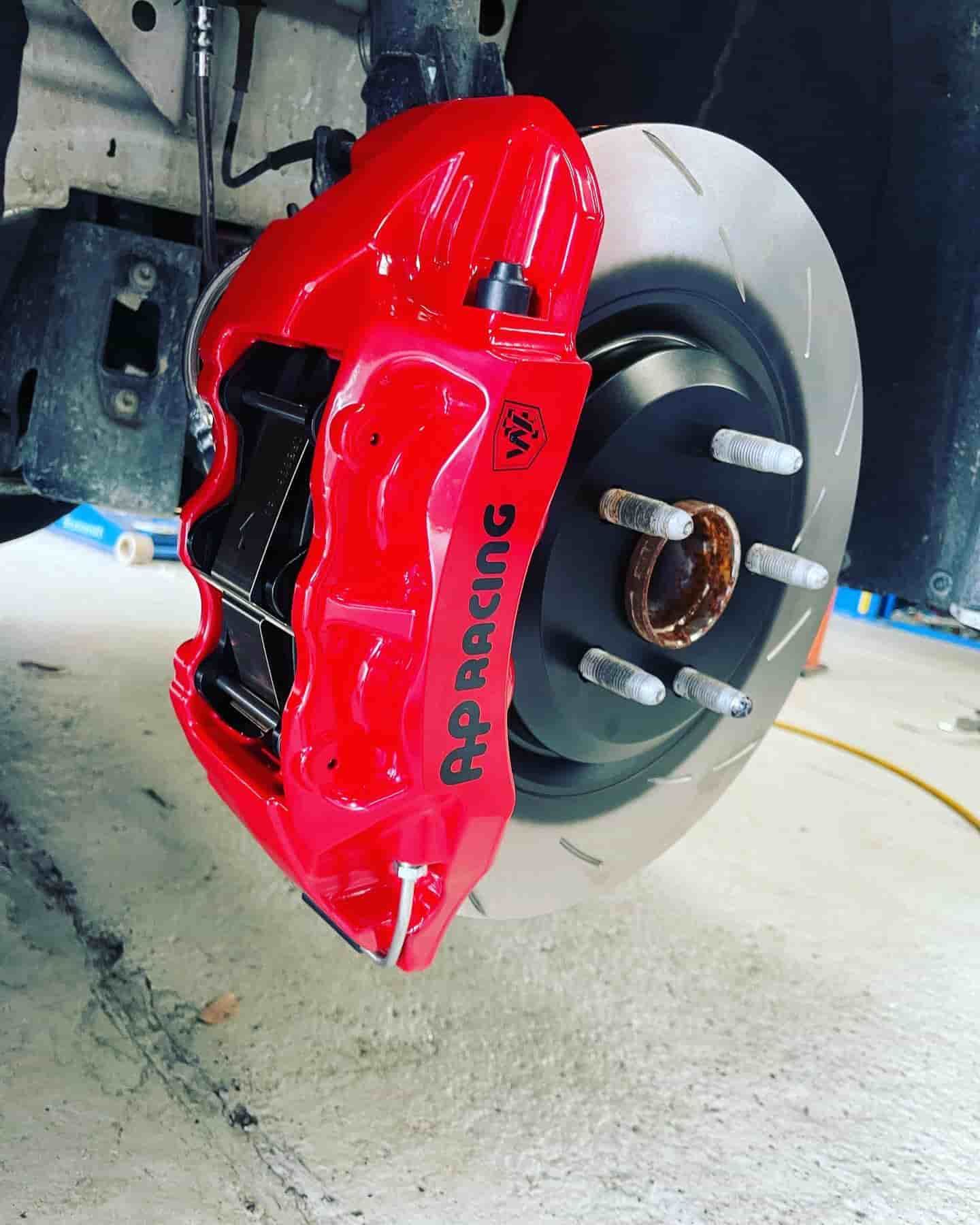A Red Brake Caliper With The Word Ap Racing On It — ProStreet Automotive & Fabrication In Cardiff, NSW
