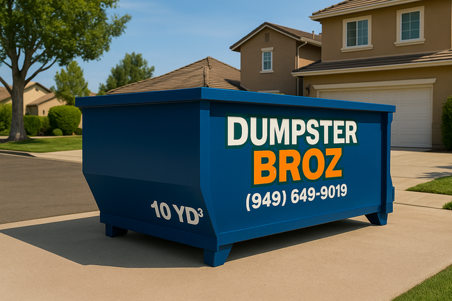 A black dumpster is sitting on top of a white surface.